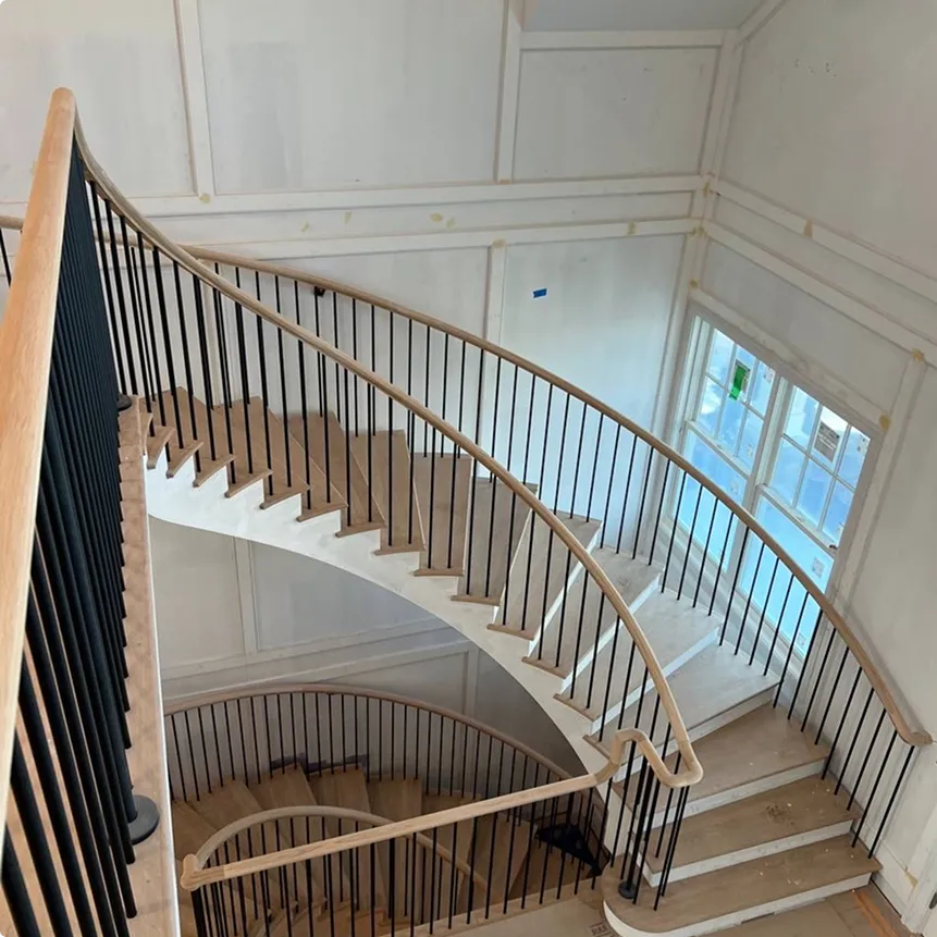 Curved Oak Staircase with Black Metal Balusters